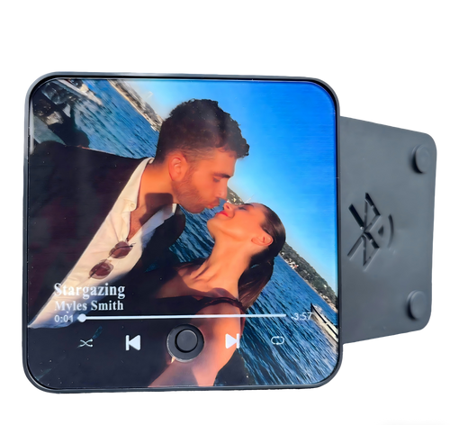 A customized musical refrigerator magnet displaying a personal photo.