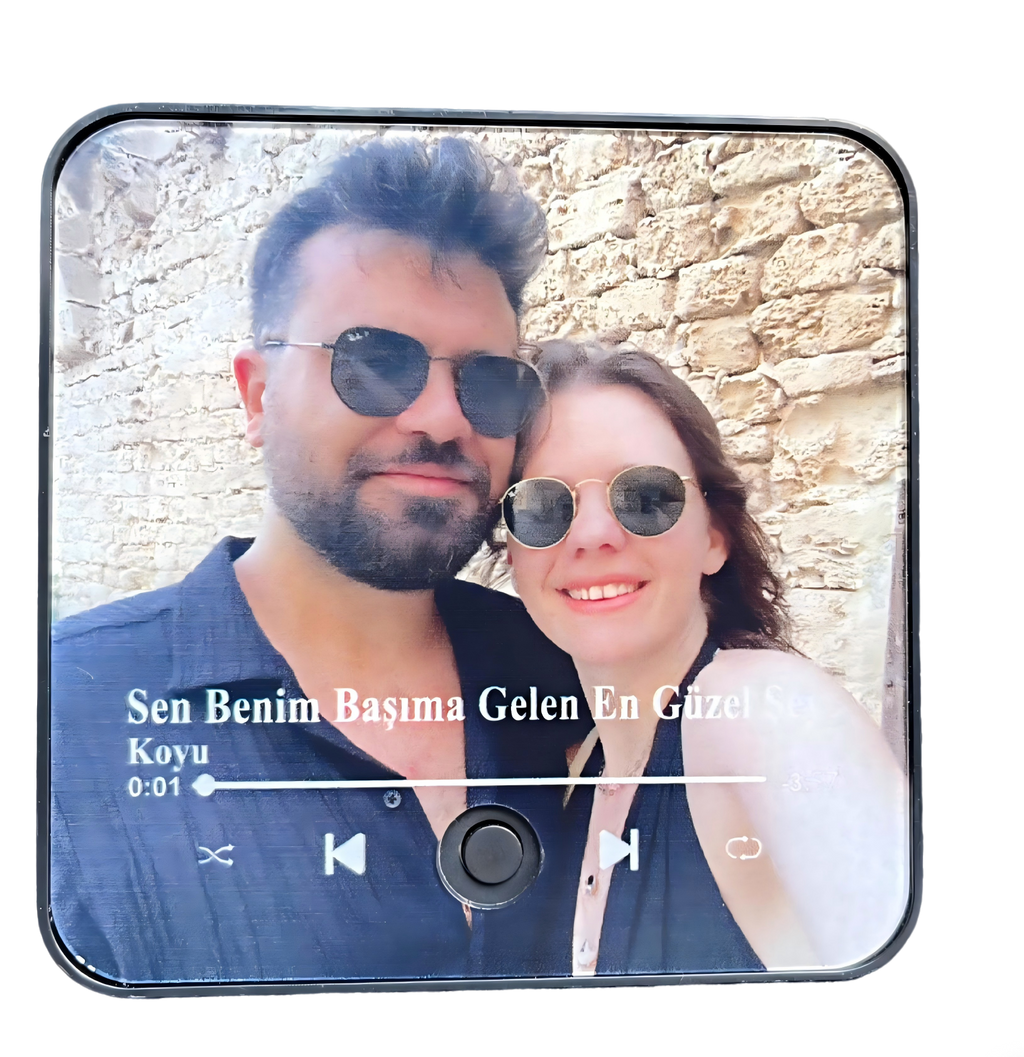 A music fridge magnet attached to a modern stainless steel refrigerator